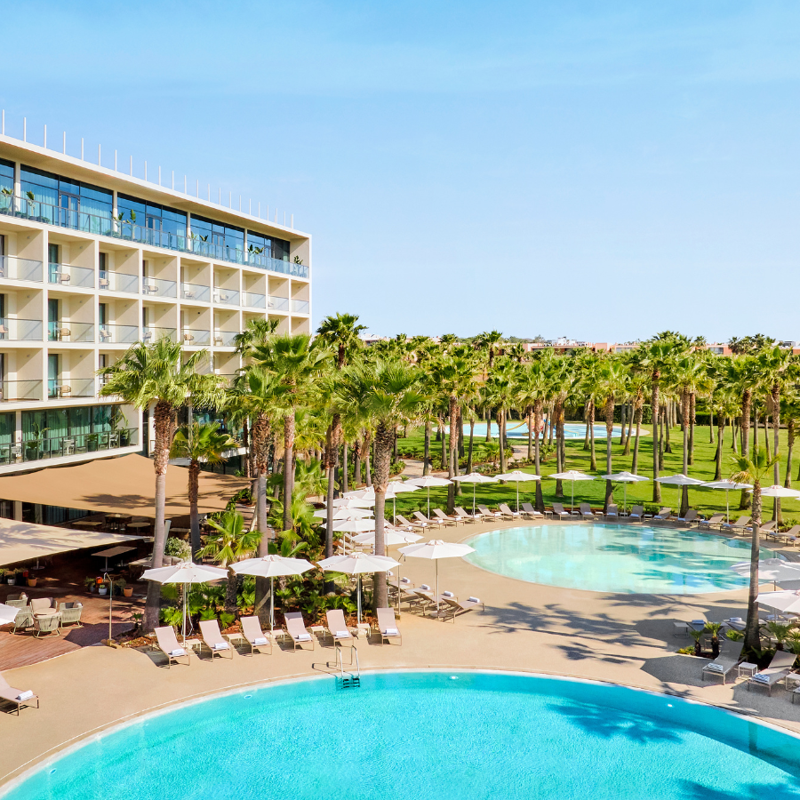 Outdoor pools framed by palm trees at algarve marriott salgados beach and spa resort